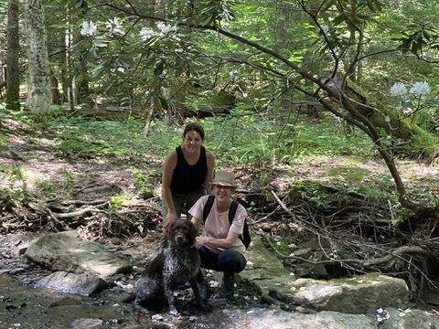 Jody and Murray on a creek with a young Griffon